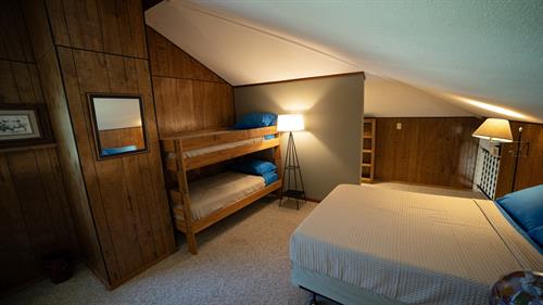 Loft bedroom provides a full bed, two singles and a view that is like being in a treehouse.