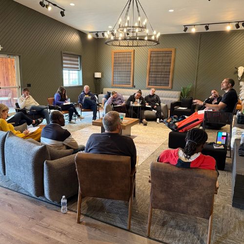 Main seating space with people engaging in a personal development retreat.