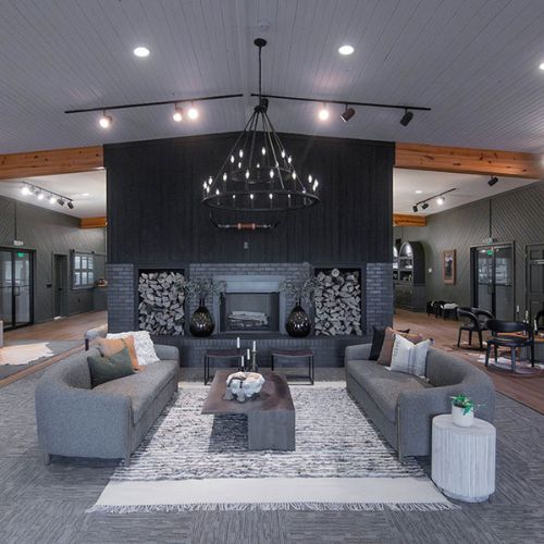 Main seating space in Culture Cove. Fire place is electric. Multiple seating spaces. Private working spaces also available in this area.