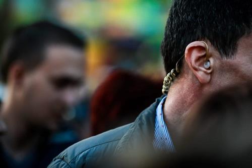 Close protection agent monitoring crowd activity with earpiece communication | Global Risk Solutions, Inc. Close protection agent monitoring crowd activity with earpiece communication | Global Risk Solutions, Inc.