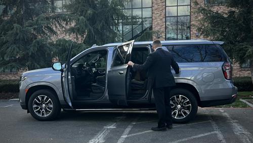 Professional security driver preparing vehicle for secure client transport | Global Risk Solutions, Inc. Professional security driver preparing vehicle for secure client transport | Global Risk Solutions, Inc.