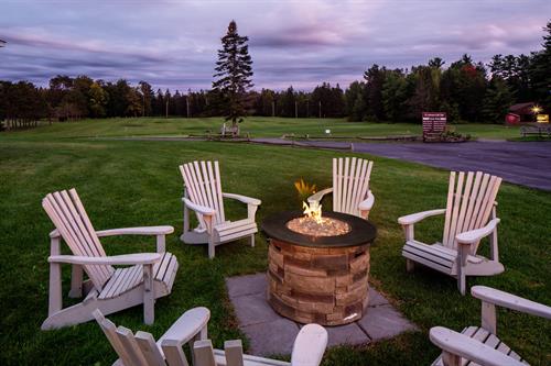 Relax around the fire while enjoying the scenic views of the golf course