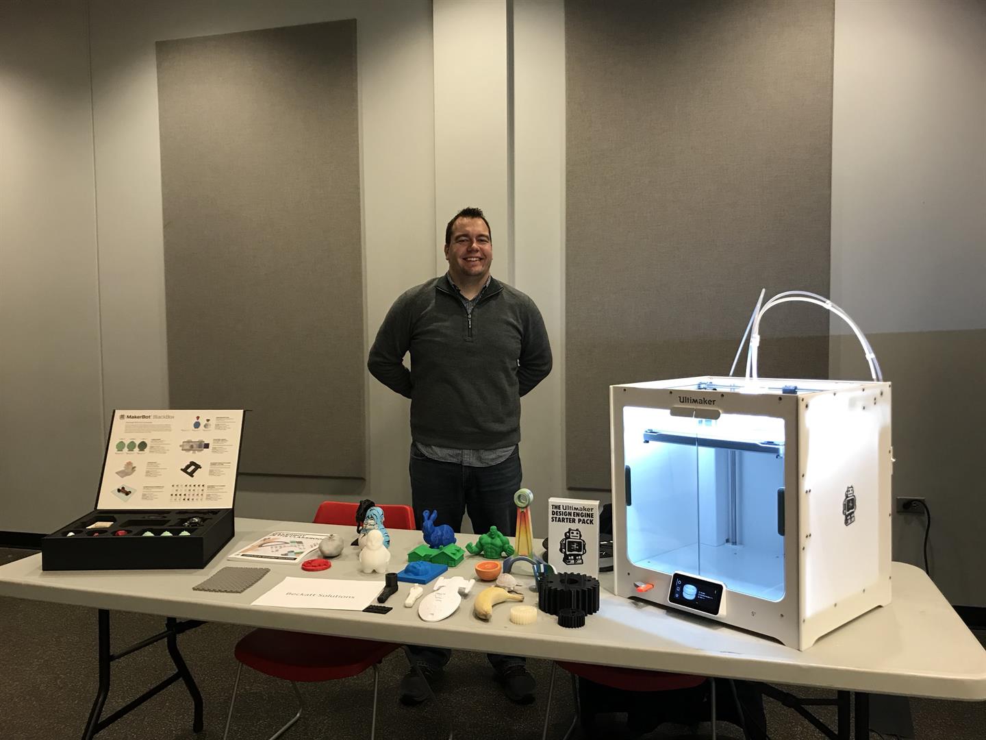 Owner Michael Storey demonstrating 3D printing and showing 3D prints.