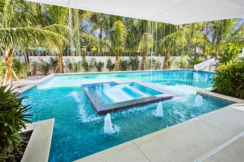 A Las Palmas' pool and rainfall hot tub complete with a spacious outdoor covered patio area.