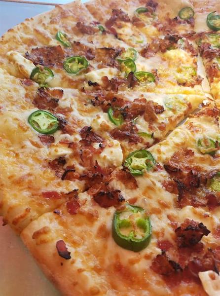 Starting with our propriety dough blend made fresh and hand tossed daily is drenched with an Apricot Thai Sweet Chili Sauce, topped with heaps of melty Cream Cheese, gooey Cheddar, Mozzarella, and finished with Crisp Bacon, Fresh Jalapeño. Perfect balance of savory, salty, sweet and spicy. Starting with our propriety dough blend made fresh and hand tossed daily is drenched with an Apricot Thai Sweet Chili Sauce, topped with heaps of melty Cream Cheese, gooey Cheddar, Mozzarella, and finished with Crisp Bacon, Fresh Jalapeño. Perfect balance of savory, salty, sweet and spicy.