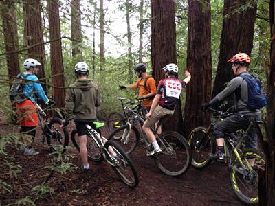 Evaluating the terrain in advanced mountain bike clinic