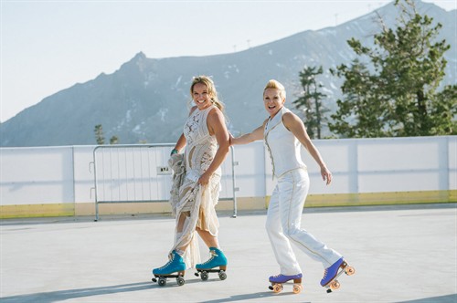 Brides rollerskating on top of Palisades Tahoe during their fun cocktail hour