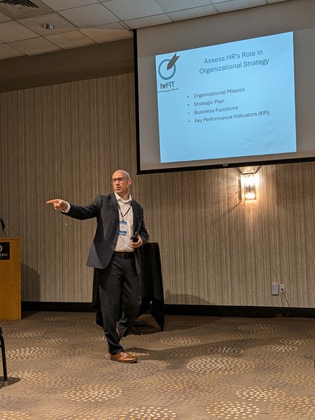 Principal Consultant Erik Christian giving HR presentation. 