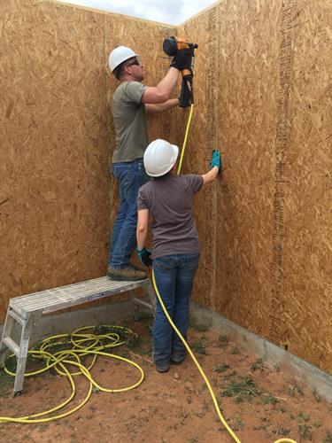 Volunteers build walls