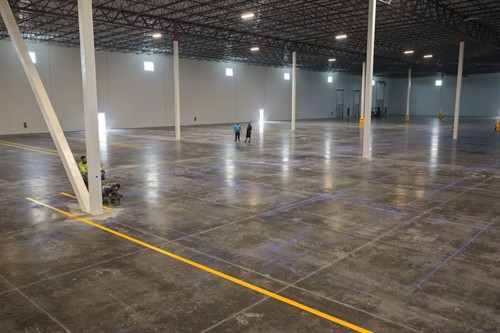 Radiant Striping crew striping yellow safety lines in 1-800-PACK-RAT warehouse, Tampa