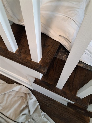 Stair tread repaired and refinished to blend cleanly with the existing woodwork.