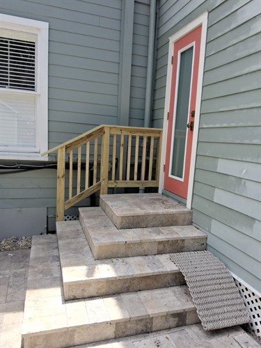 New wood handrail installed to improve safety and provide a sturdy, finished access point.