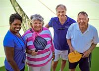 Carolyn Leevy, Fitness Director for Foulkeways for nearly 25 years, spends time playing pickleball with residents on a gorgeous day