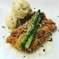 White cheddar fried chicken with roasted asparagus, red mashed potatoes, and a basil cream sauce.