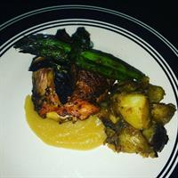 smoked chicken thigh stuffed with chicken apple sausage, smoked apple sauce, and asparagus