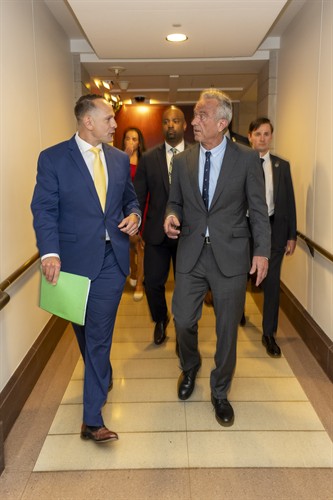 John Koufos discussing healthcare with Secretary Kennedy before a large announcement at the U..s. Capitol