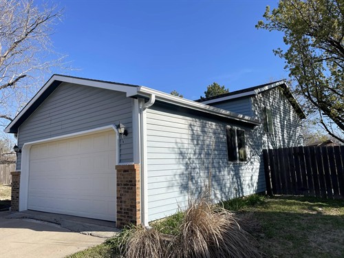 Fascia repaired then wrapped, garage door trim wrapped, and new seamless gutters installed Mid-Continent Exteriors LLC