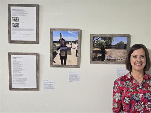 Robin with advocacy photos and poetry at SOS Cincinnati Art Show