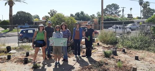 Robin and team planting a new native pollinator garden next to food garden at a school for traumatized children