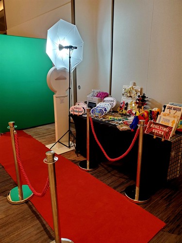 Photo Booth Green Screen Setup with Red Carpet and Stanchions
