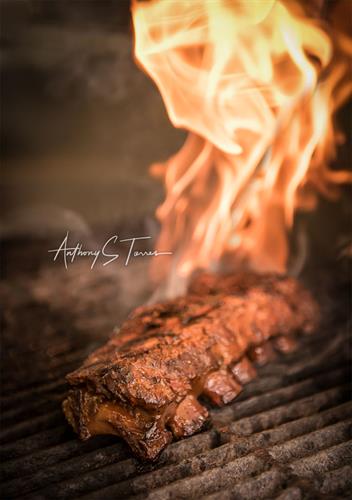 Food Photography: Combining splashes of oil to create the fire around a great rack of ribs. Immediately led to customers asking and ordering when posted.
