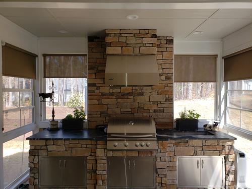 Outdoor kitchen in an enclosed porch
