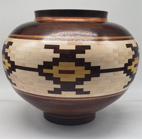 The Dancers Native American style vessel.  Peruvian walnut, maple, Bloodwood, Yellowheart
