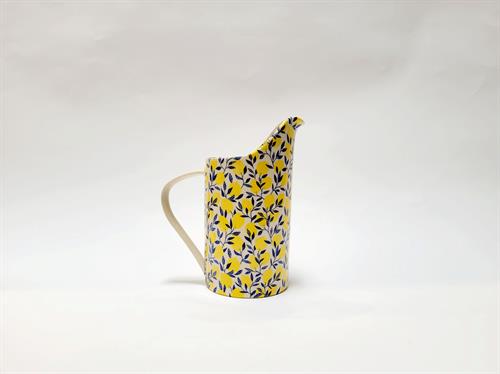 pitcher with yellow lemons and blue leaves