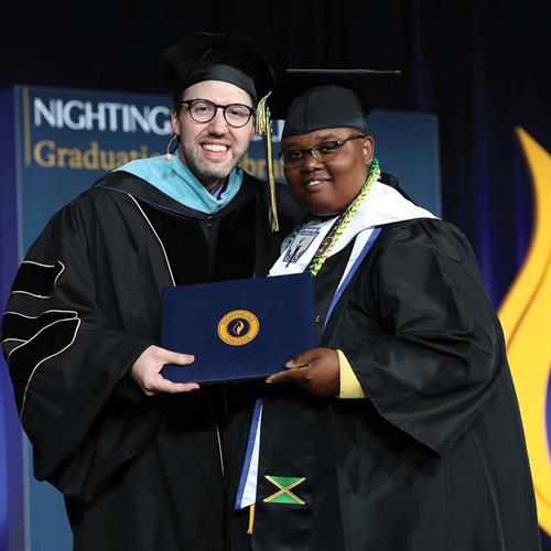 Nightingale College President with a graduating learner