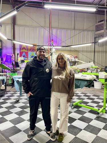 Owners Brendan and Kristina at their warehouse where we design, screen print and embroider all of our products right here on Cape Cod.