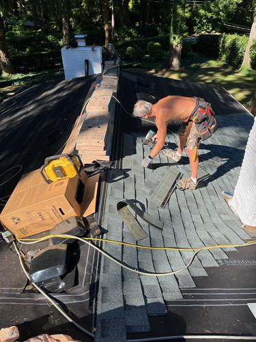 Crew working hard installing roof by French Roofing
