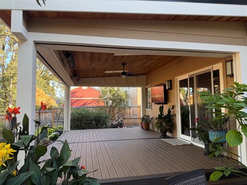Trex decking and a custom patio cover with a Japanese cedar ceiling, recessed lighting, and motorized screens.