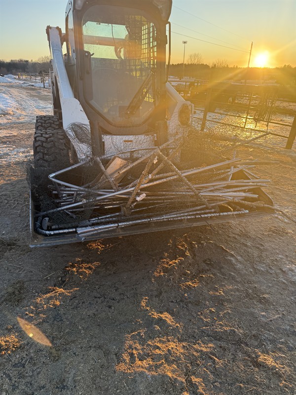 Skid loader full of scrap from a junk removal service.