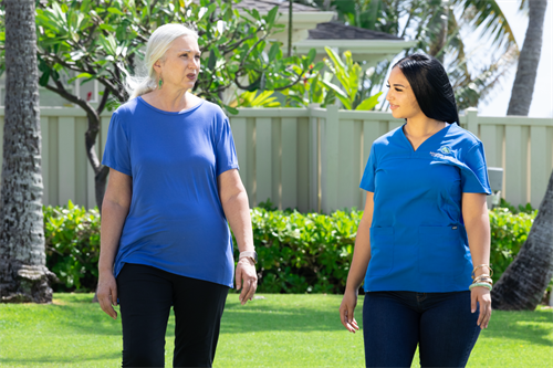 Caregiver and Client walking outside while conversing in Honolulu, Hawaii