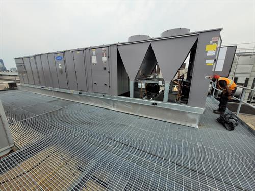 Photo of our technicians doing maintenance on a rooftop unit, Photo of our technicians doing maintenance on a rooftop unit,