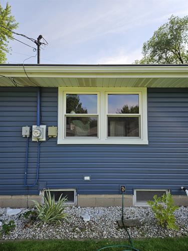 Crisp new windows and deep blue siding give this Appleton, WI home a fresh, modern look with energy-efficient performance.