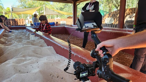 Dallas capturing video of a child in the sand