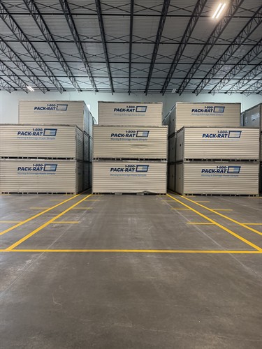 Interior warehouse floor marking layout around stacked containers at 1-800-PACK-RAT Tampa