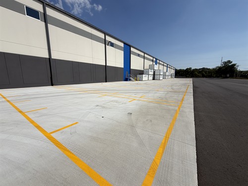 Yellow loading zone striping on exterior concrete at 1-800-PACK-RAT distribution center