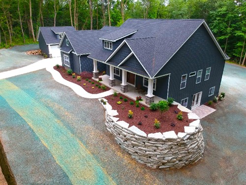 Residential landscape with ledge rock retaining walls and steps