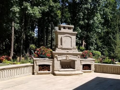 Brick outdoor fireplace and patio with brick retaining wall