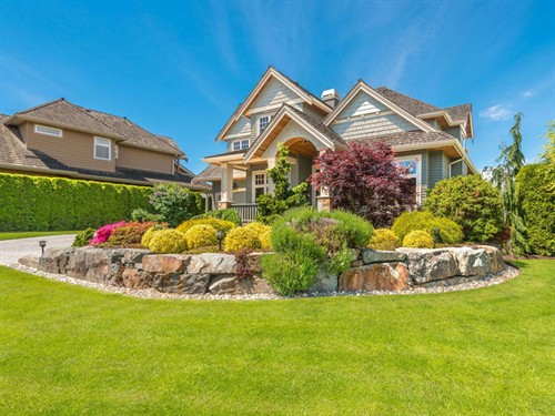 Residential landscape with natural boulder retaining wall