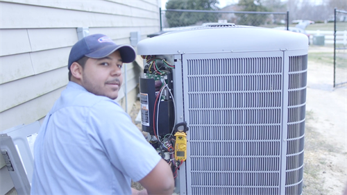 HVAC Tech working on Air Conditioning Unit 