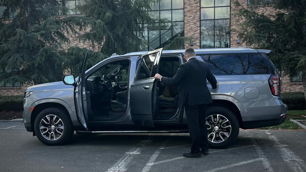 Professional security driver preparing vehicle for secure client transport | Global Risk Solutions, Inc. Professional security driver preparing vehicle for secure client transport | Global Risk Solutions, Inc.