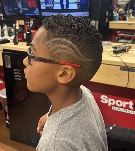 High fade with a freehand custom wave design carved into the side, a boys' haircut at Sport Clips Haircuts in the Sarasota and Manatee County area.