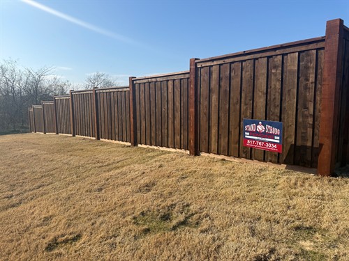 6' pre-stained Western Red Cedar fence in the board-on-board style with top cap and trim with 6x6 post installed by Stand Strong Fencing of Fort Worth