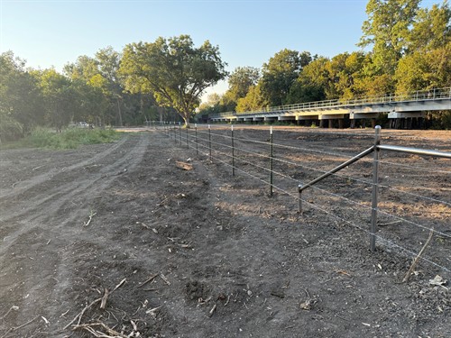 T-post with barbed wire installed by Stand Strong Fencing of Fort Worth