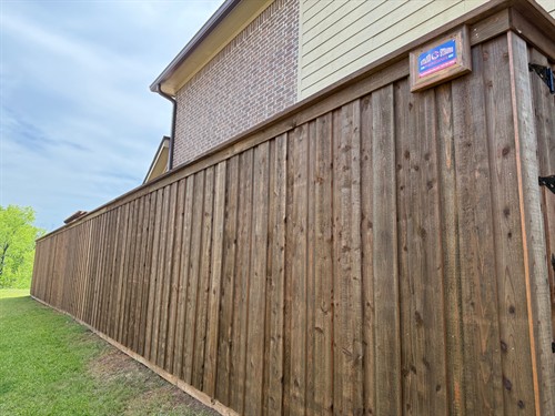 8' pre-stained cedar fence in the board-on-board style with top cap and trim installed by Stand Strong Fencing of Fort Worth