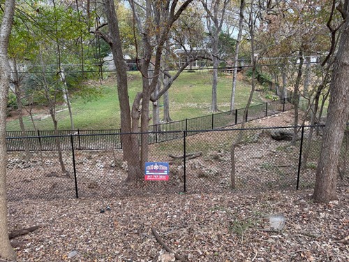 6' Chain link fence coated with black vinyl installed by Stand Strong Fencing of Fort Worth