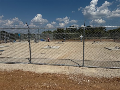 Commercial chain link fence with 3 rows of barbed wire installed by Stand Strong Fencing of Fort Worth